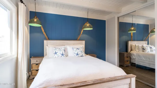 a bedroom with a bed and a mirror