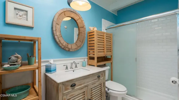 a bathroom with a toilet a sink and a mirror
