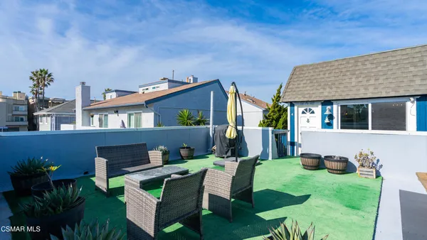a view of house with a chairs in patio