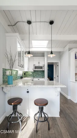 a kitchen with a table and chairs
