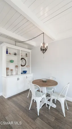 a dining room with a wooden table and chairs
