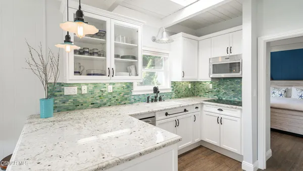 a kitchen with a sink and a stove top oven