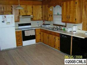 702 Miles Road Dallas, NC 28034 - Photo 2 of 7 a kitchen with stainless steel appliances granite countertop a stove a sink and a microwave