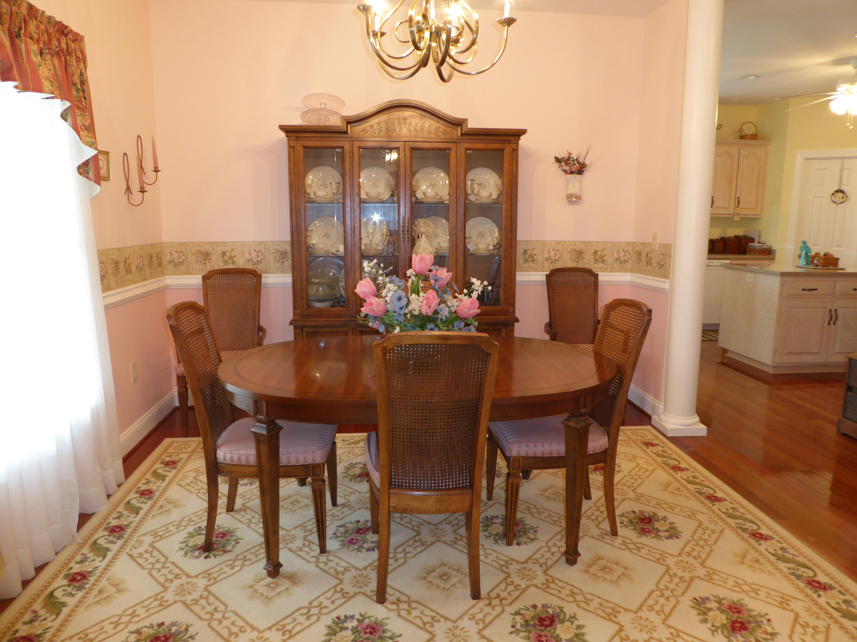 12419 Callaway Road Callaway, VA 24067 - Photo 6 of 96 a dining room with furniture a rug and a chandelier