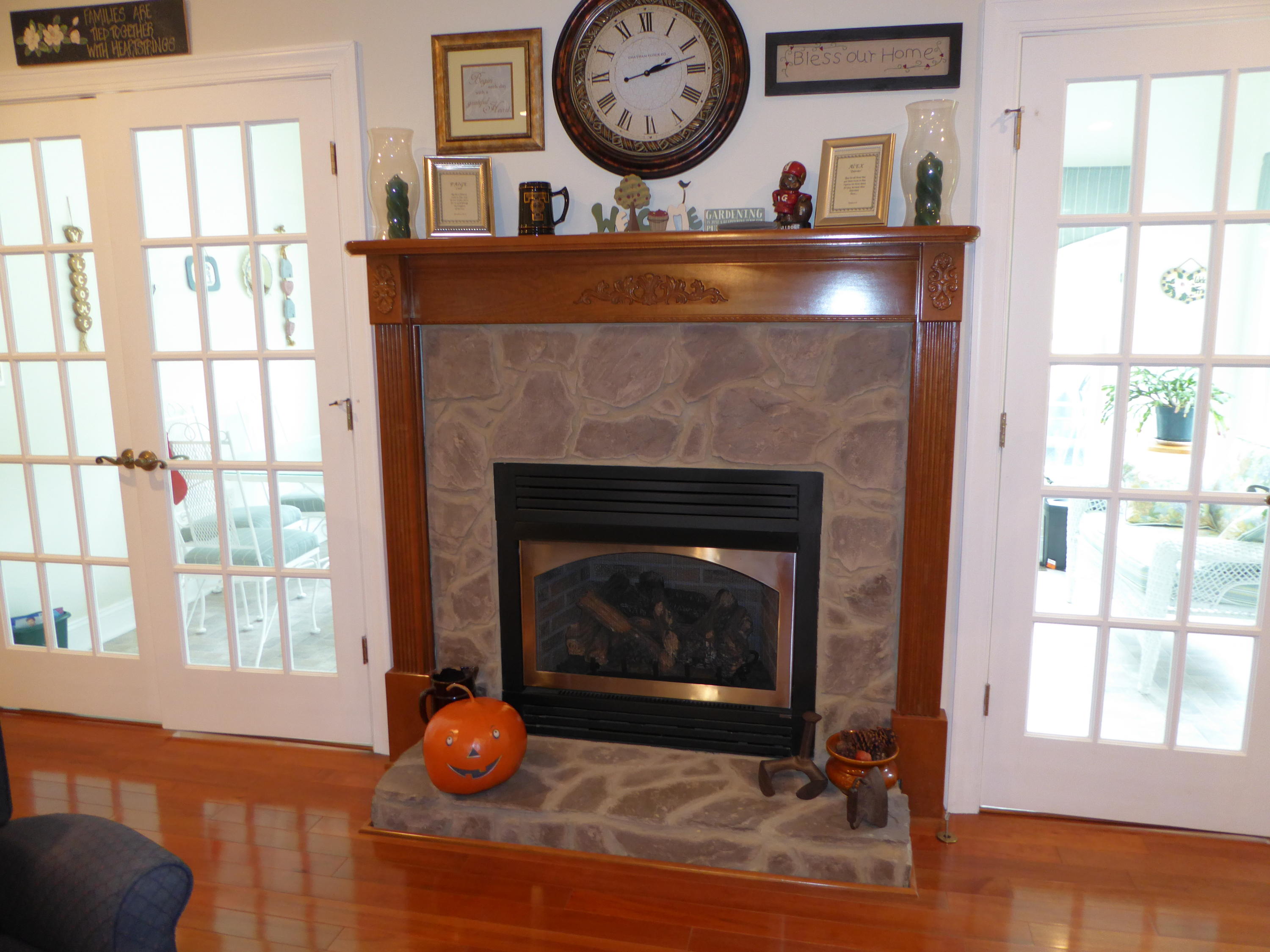 12419 Callaway Road Callaway, VA 24067 - Photo 76 of 96 a living room with a fireplace a clock and a large window