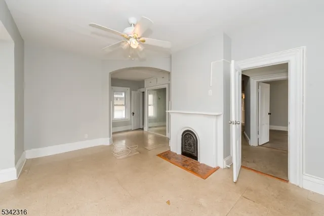 a view of a livingroom with a fireplace a chandelier and closet