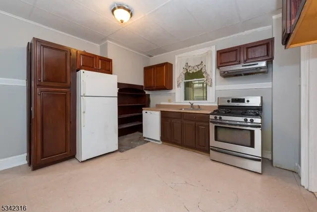 a kitchen with stainless steel appliances a refrigerator stove and microwave