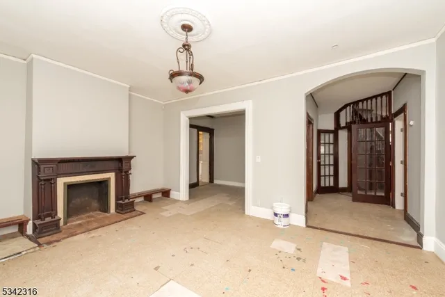 a view of a livingroom with a fireplace and window