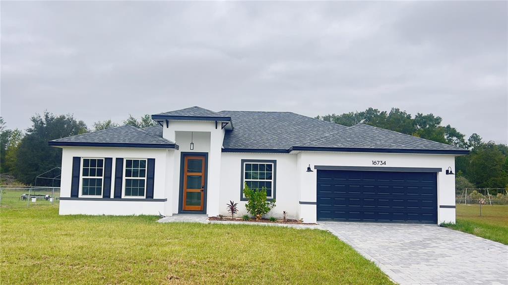 16734 Southwest 18th Avenue Road Ocala, FL 34473 - Photo 1 of 36 front view of a house with a yard