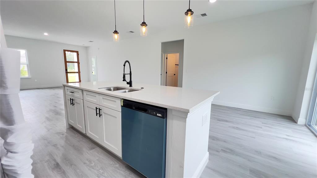 16734 Southwest 18th Avenue Road Ocala, FL 34473 - Photo 11 of 36 a kitchen with a sink cabinets and wooden floor
