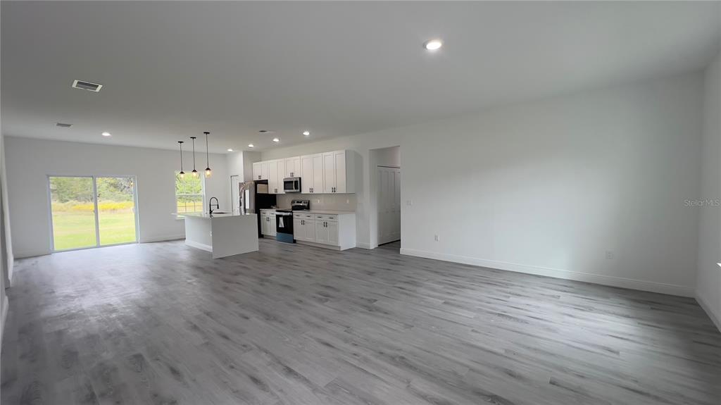 16734 Southwest 18th Avenue Road Ocala, FL 34473 - Photo 2 of 36 a view of empty room with wooden floor