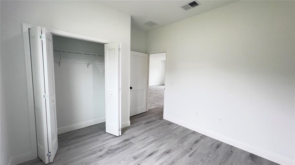 16734 Southwest 18th Avenue Road Ocala, FL 34473 - Photo 23 of 36 a view of an empty room with wooden floor