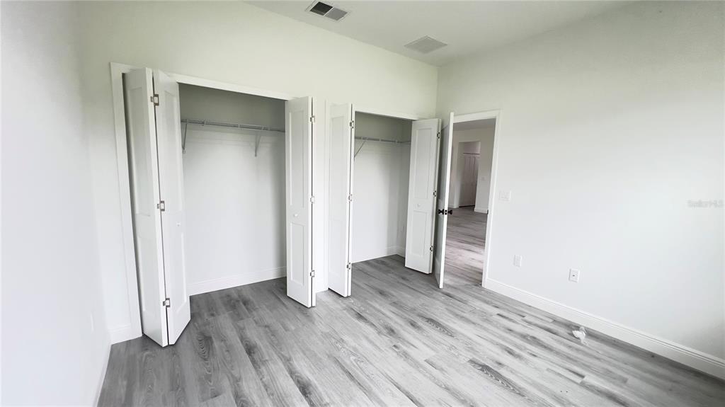 16734 Southwest 18th Avenue Road Ocala, FL 34473 - Photo 30 of 36 an empty room with wooden floor and closet