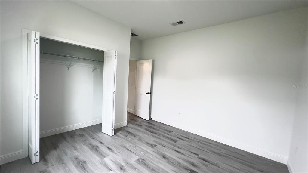 16734 Southwest 18th Avenue Road Ocala, FL 34473 - Photo 32 of 36 an empty room with wooden floor and closet