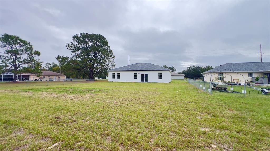 16734 Southwest 18th Avenue Road Ocala, FL 34473 - Photo 34 of 36 a front view of a house with garden