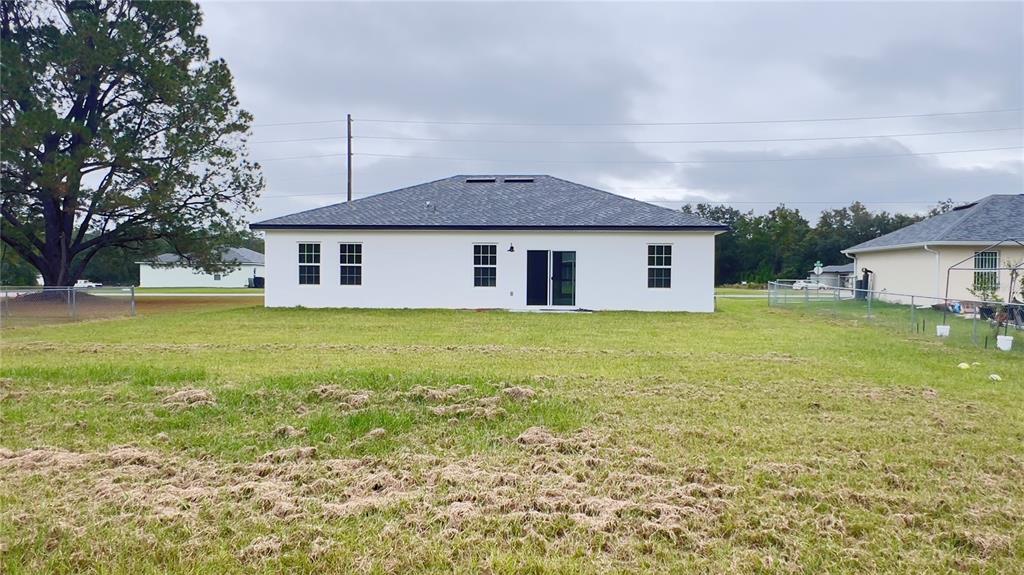 16734 Southwest 18th Avenue Road Ocala, FL 34473 - Photo 35 of 36 a front view of house with yard and ocean