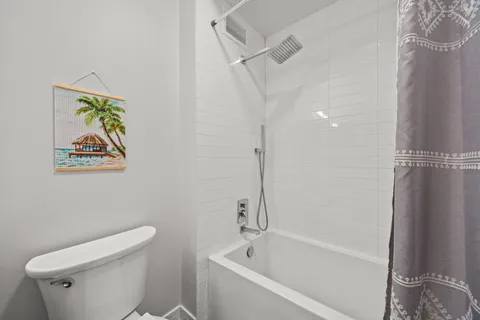 a white bath tub sitting next to a white toilet