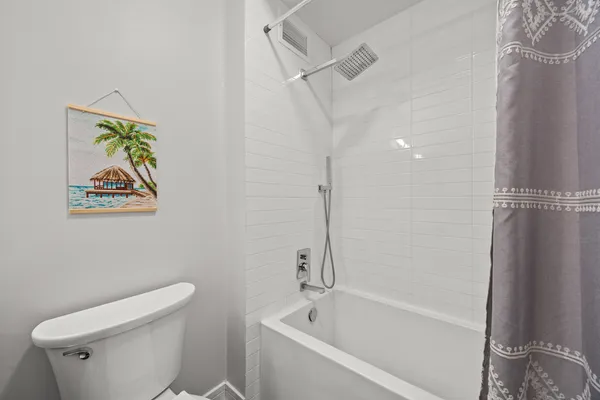 a white bath tub sitting next to a white toilet