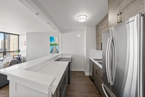 a kitchen with stainless steel appliances a refrigerator and a stove