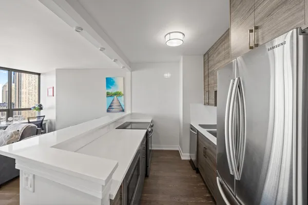 a kitchen with stainless steel appliances a refrigerator and a stove