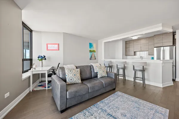 a living room with furniture and a wooden floor