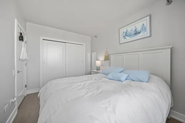 a bedroom with a bed and a painting on the wall