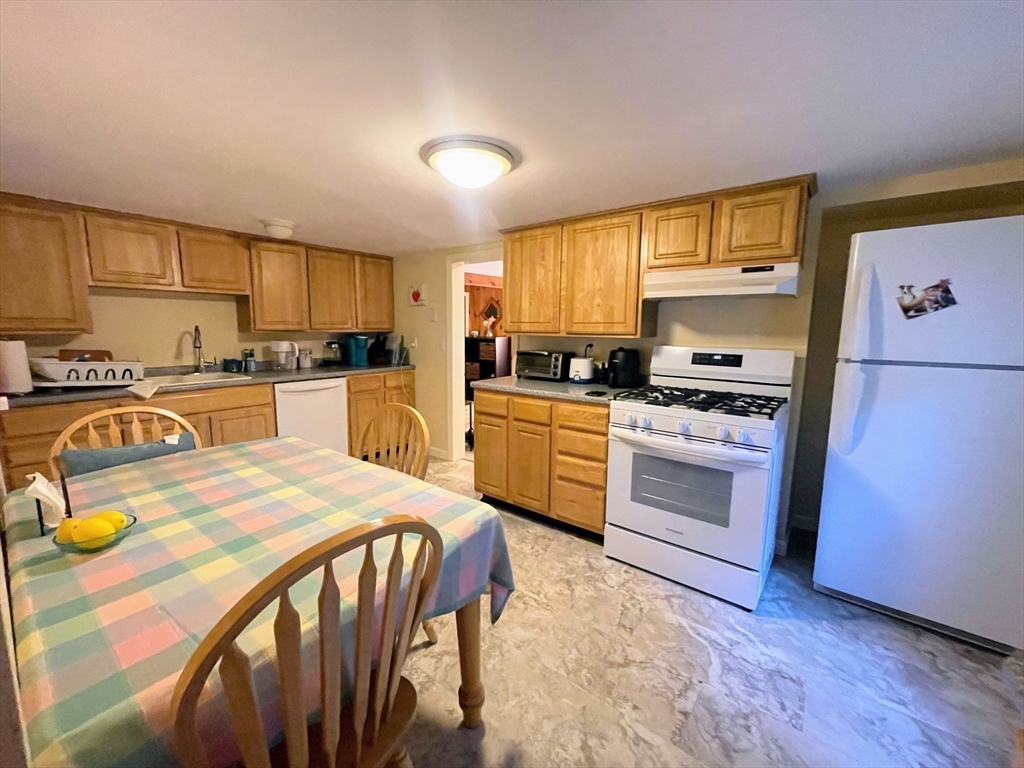 36 Old Battery Road Townsend, MA 01474 - Photo 15 of 33 a kitchen with a sink a stove a refrigerator cabinets and a window