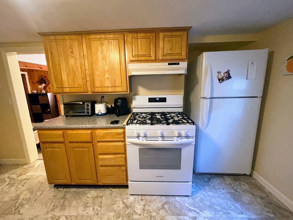 36 Old Battery Road Townsend, MA 01474 - Photo 18 of 33 a kitchen with white cabinets and white appliances