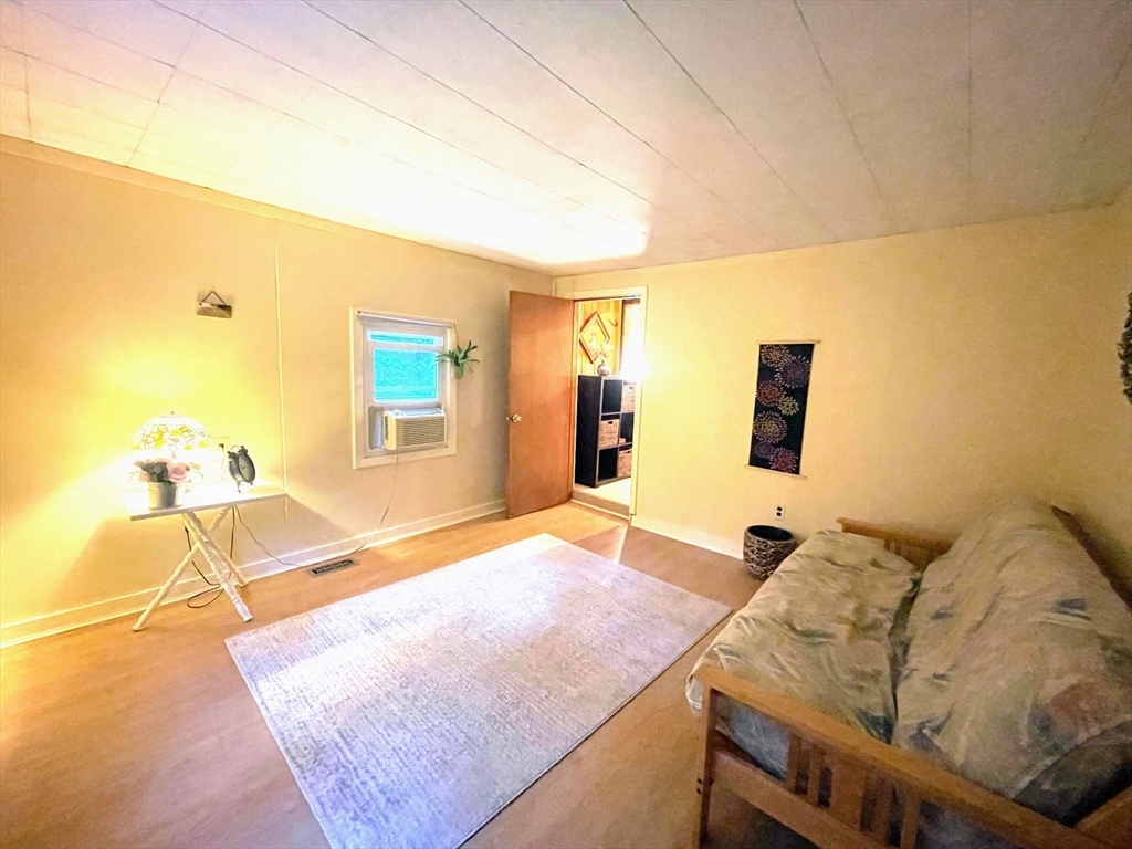 36 Old Battery Road Townsend, MA 01474 - Photo 20 of 33 a bedroom with a bed and wooden floor