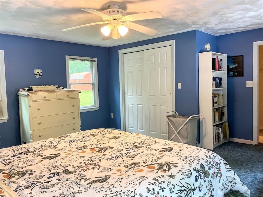 36 Old Battery Road Townsend, MA 01474 - Photo 24 of 33 a bedroom with a bed and a chandelier