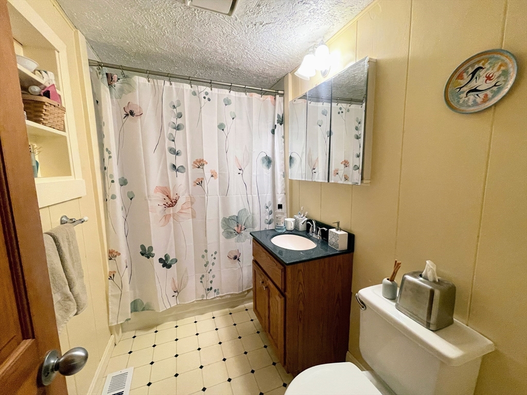 36 Old Battery Road Townsend, MA 01474 - Photo 26 of 33 a bathroom with a sink a toilet a mirror a vanity and shower