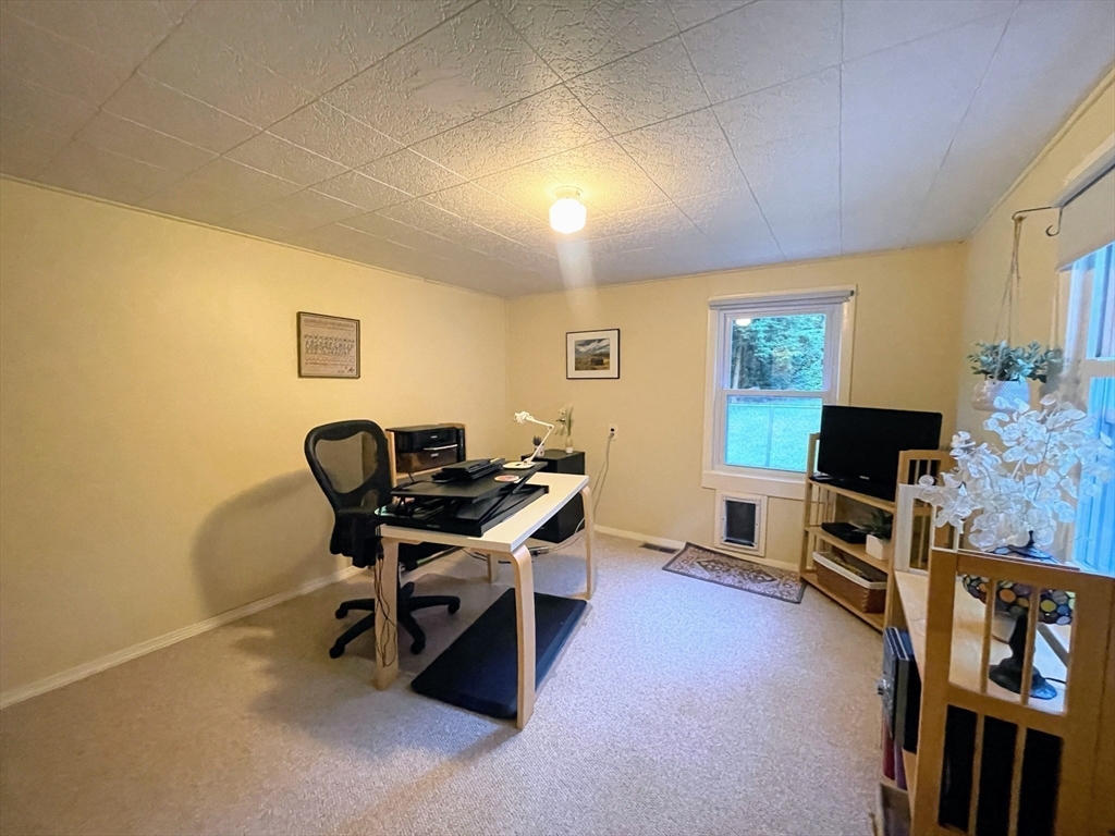 36 Old Battery Road Townsend, MA 01474 - Photo 27 of 33 a view of a workspace with furniture and a flat screen tv