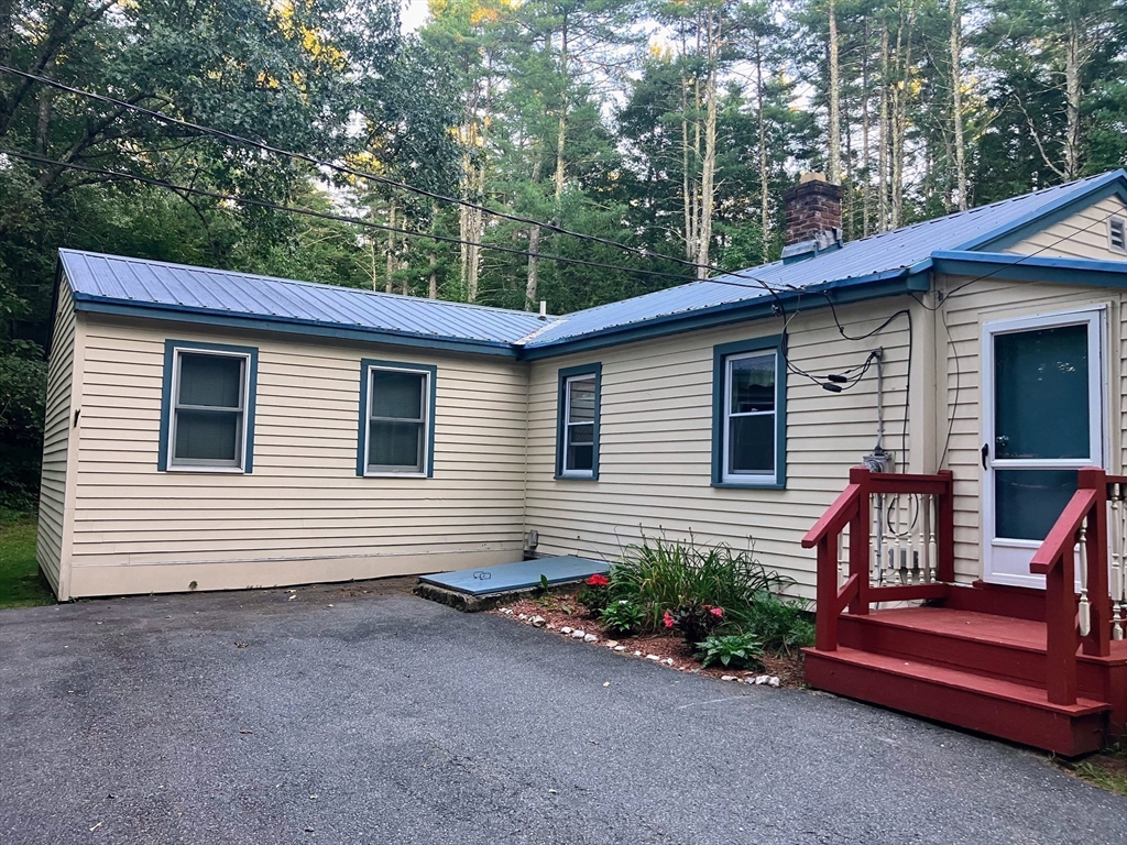 36 Old Battery Road Townsend, MA 01474 - Photo 5 of 33 a view of a house with a yard and furniture