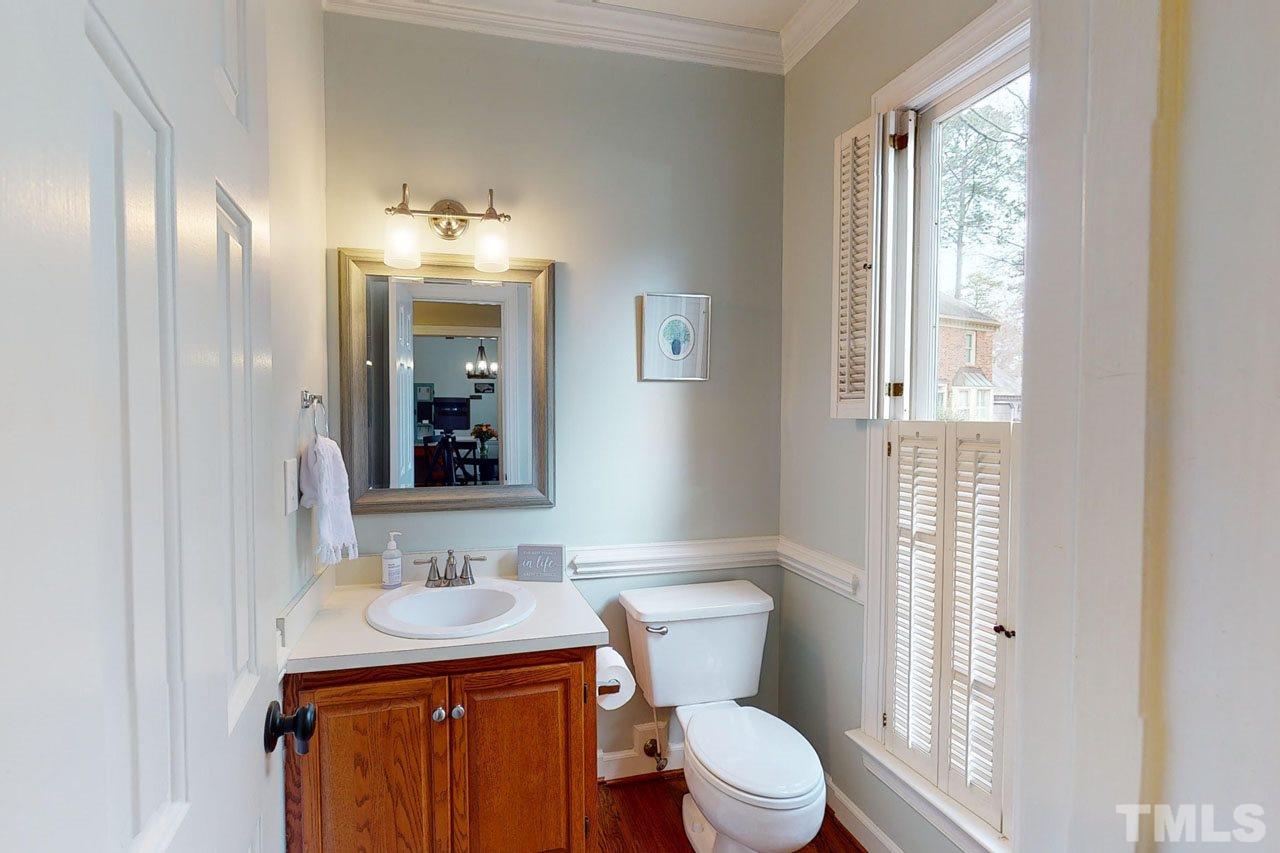 6008 Cobridge Square Raleigh, NC 27609 - Photo 6 of 30 Half bathroom on main floor has plantation shutters