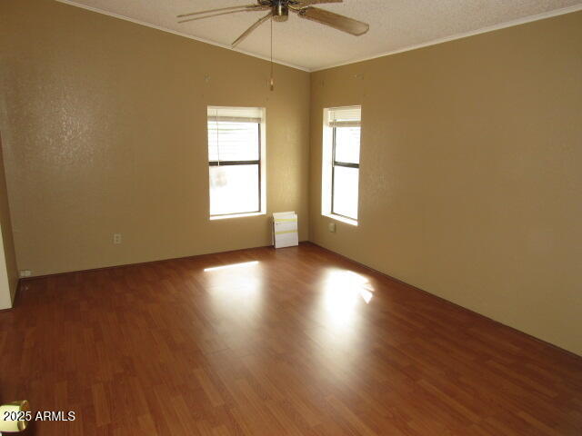 3411 South Camino Seco, Unit 443 Tucson, AZ 85730 - Photo 13 of 20 wooden floor in an empty room with a window