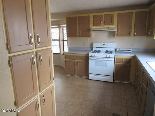 a kitchen with a sink a stove and refrigerator