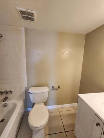 a bathroom with a toilet and a bathtub