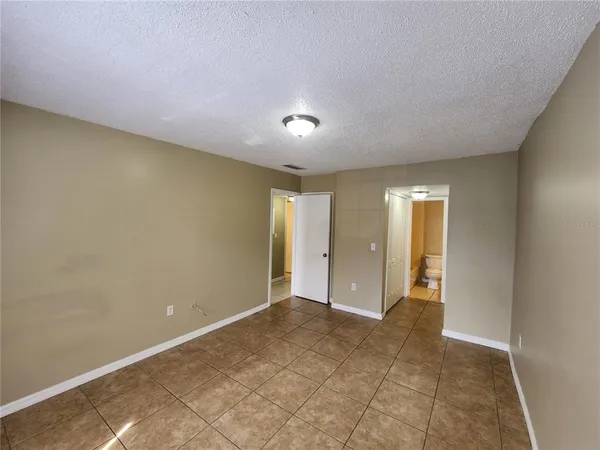 an empty room with a empty space and windows