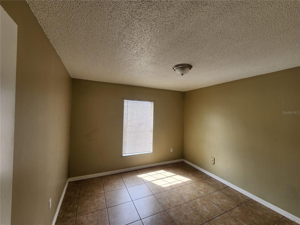 5228 Curry Ford Road, Unit 320 Orlando, FL 32812 - Photo 17 of 19 an empty room with a empty space and windows