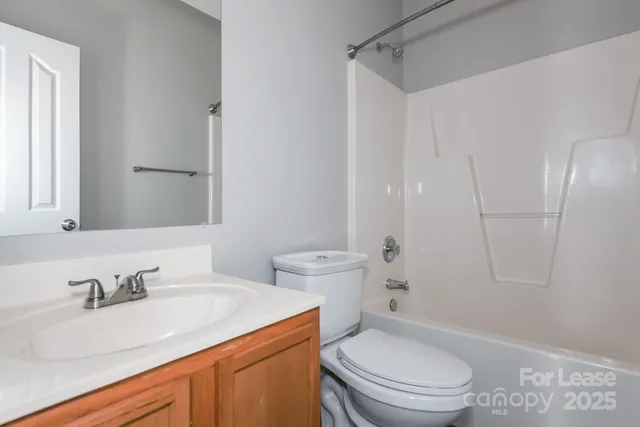 a bathroom with a sink toilet vanity and shower