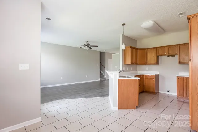a kitchen with a refrigerator and a stove