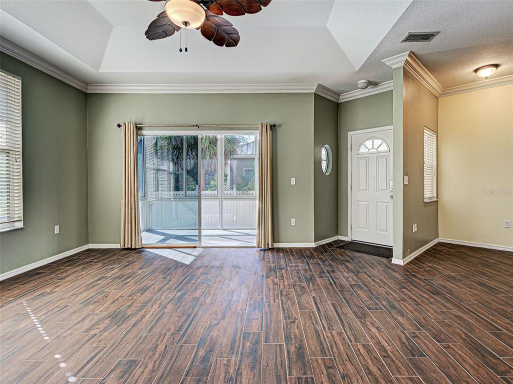 1801 Highland Road Osprey, FL 34229 - Photo 7 of 40 an empty room with wooden floor and windows