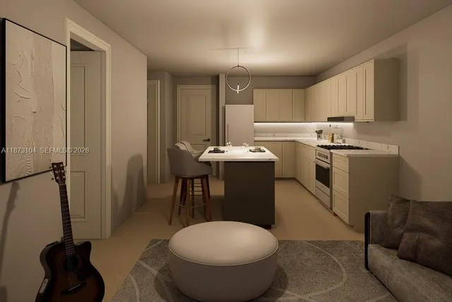 a kitchen with a sink a counter space and a refrigerator