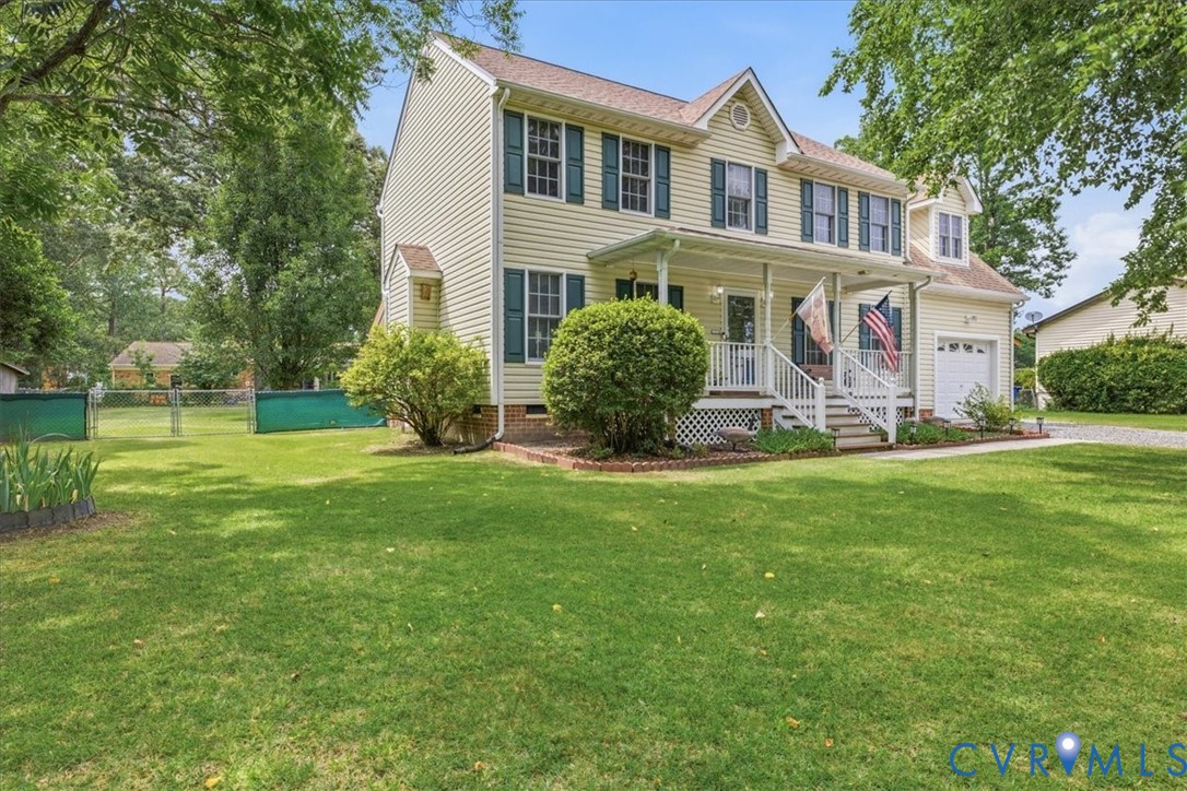 Two-story Colonial home featuring a cream-colored