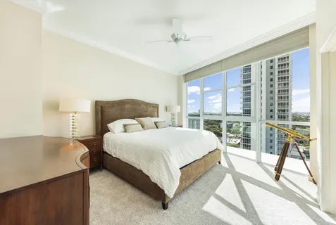 a spacious bedroom with a bed and a large window