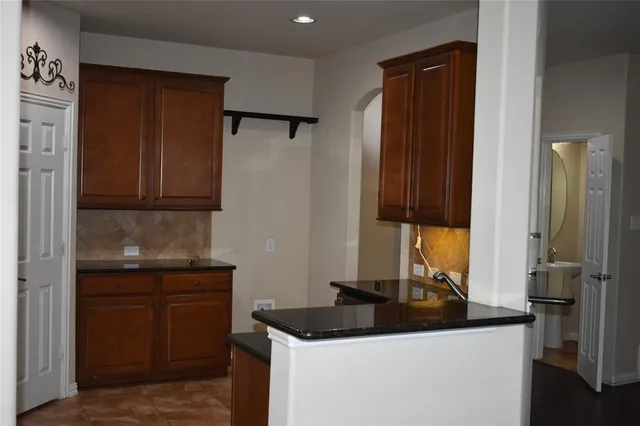 a kitchen with a sink and a refrigerator