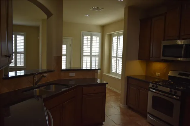 a kitchen that has a sink and a stove in it