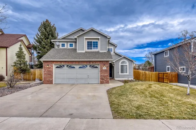 a view of a house with a yard and garage