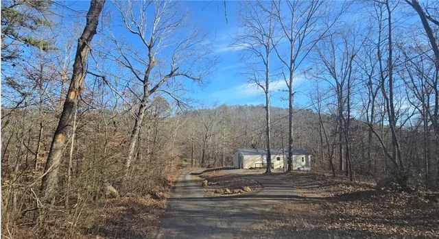 a view of a kitchen with a sink and wooden floor