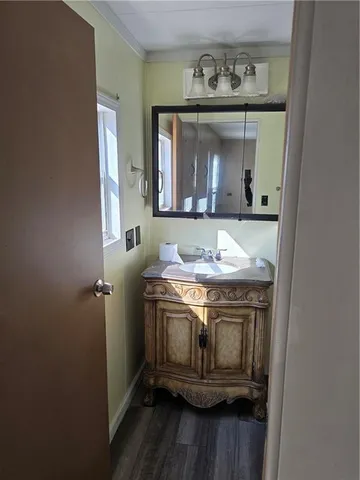a spacious bathroom with a granite countertop toilet a sink and a mirror